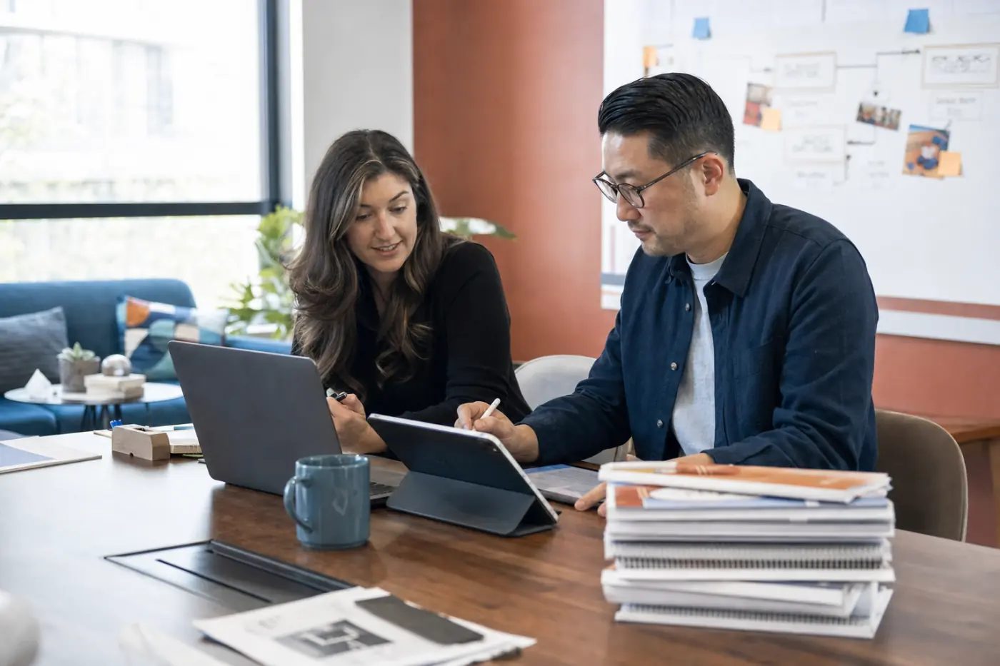 Two colleagues reviewing digital training content